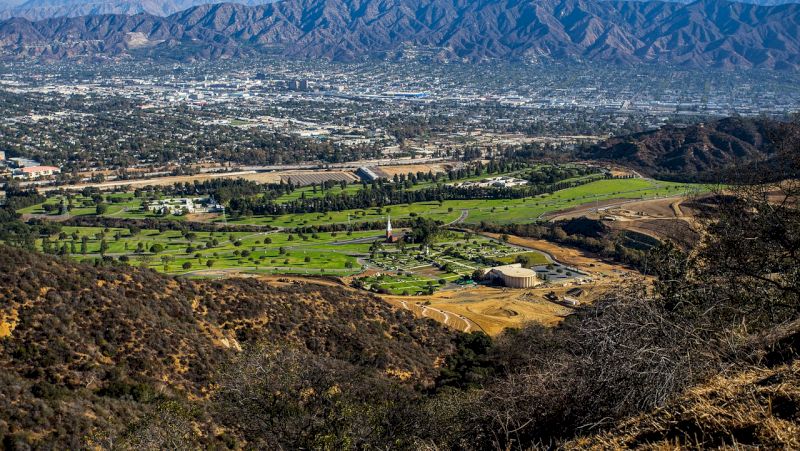 a wide aerial view of a golf course and city